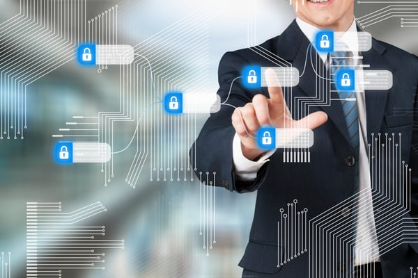 Businessman touching a digital security interface with padlock icons.
